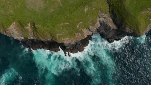 Aerial Birds Eye Overhead Top Down View of Waves Crashing on Cliffs