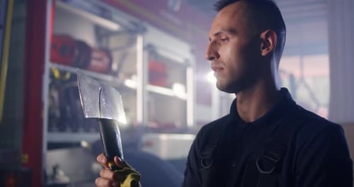 Fireman Cleaning Axe During Work