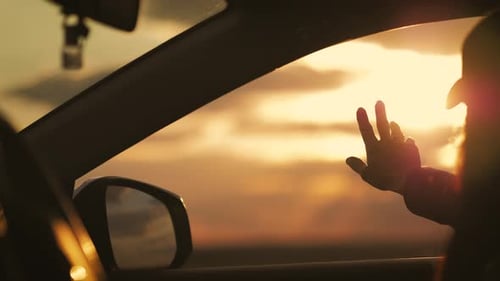 Sunset Road Trip Reflection Through Car Window