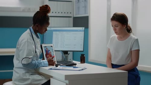 Doctor Explains Heart Condition to Patient in Office