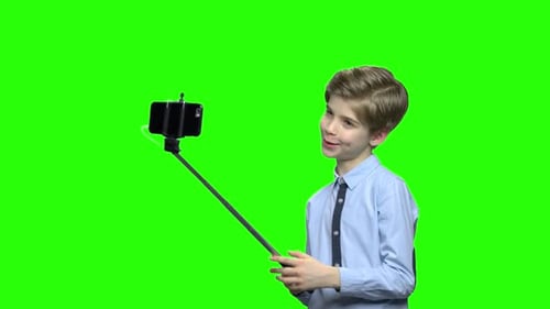 Boy Taking Selfie with Phone on Green Screen