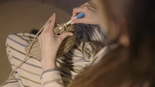 Close Up Woman Crocheting with Knitting Needles with Jute Fibre for Home Decor, Evening