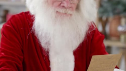 Santa Claus Reads Christmas Letter with a Smile