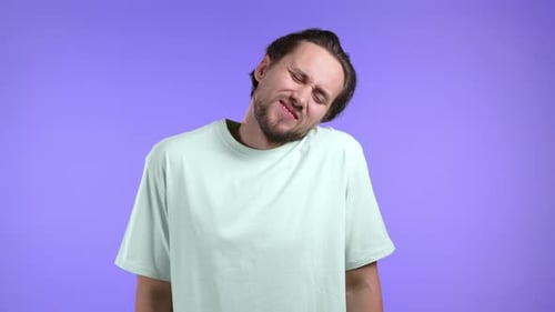 Man Stretches Out his Neck in Discomfort