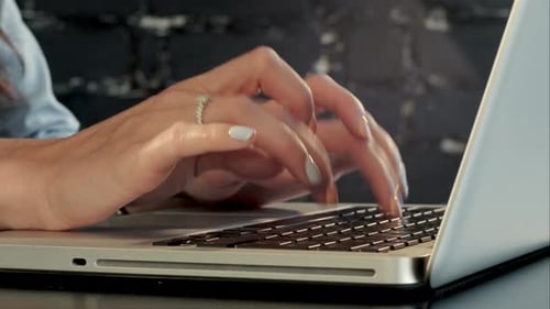 Hands Typing on Laptop Keyboard Close-Up