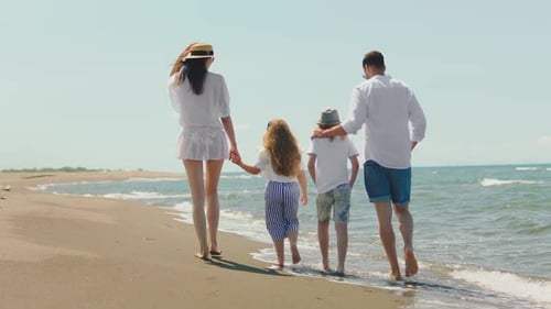 Family walking along coast and talking