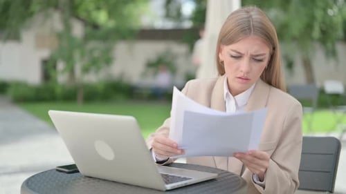 Stressed Woman Working on Laptop Outdoors