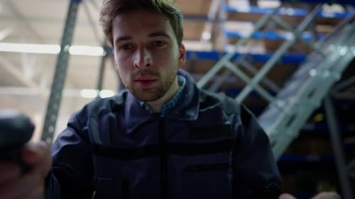 Cargo POV of Young Man Using Barcode Scanner Standing in Industrial Warehouse Indoors