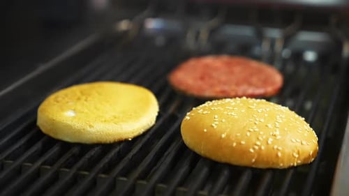 Burger Buns and Patty on a Hot Grill