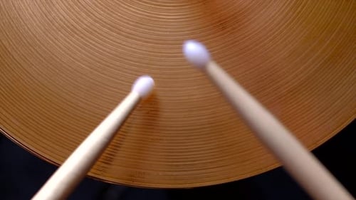 Drumsticks Hitting Golden Musical Cymbal Close Up