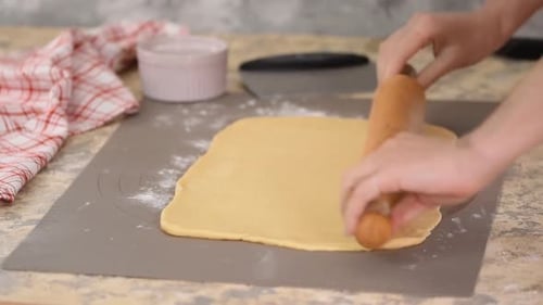 Dough Being Rolled Out with Rolling Pin