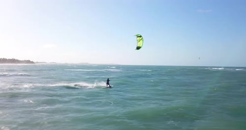 Aerial drone view of a man kiteboarding on a kite board