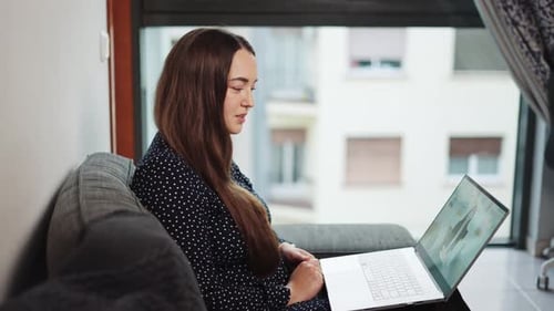 Young Woman Suffering From Mental Health Issues Talking with Psychologist Online on Laptop From Home