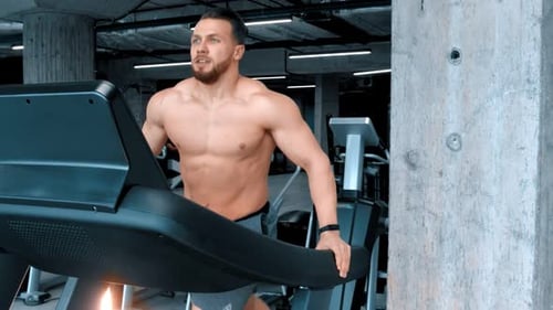 Muscular Man Working Out on Treadmill at Gym