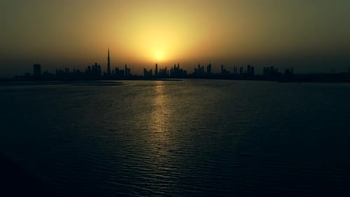 Grading aerial view of Dubai skyscrapers at sunset, UAE.