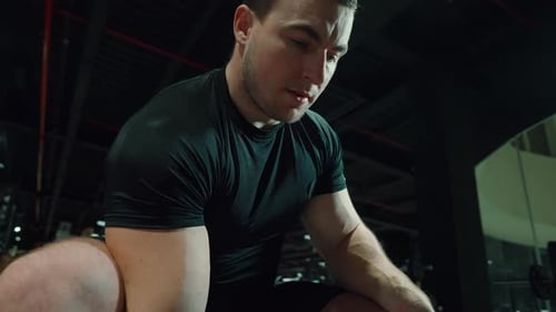 Muscular Man Lifting Dumbbell During Bicep Workout