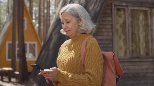 Senior Woman in Tourist Camp in Woods