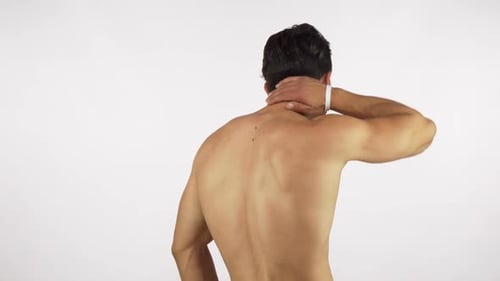 Man Massaging His Neck in Discomfort