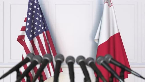USA and Malta Flags with Microphones for Press Conference