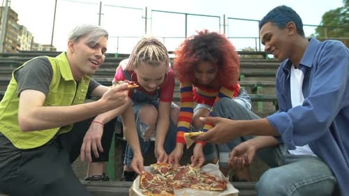 Friends Share Pizza in City Setting