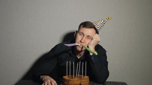 Bored Man at Birthday Party With Cake