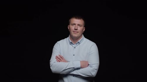 Man in Light Blue Shirt with Arms Crossed