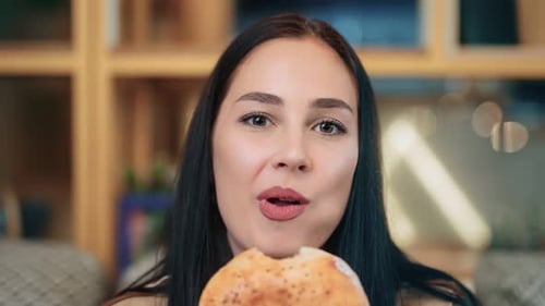 Woman Eating Round Pastry Close Up View