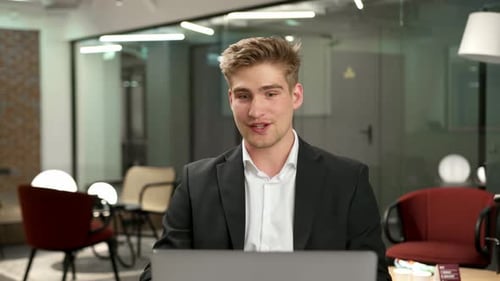 Male office worker communicates in zoom with work colleagues or clients