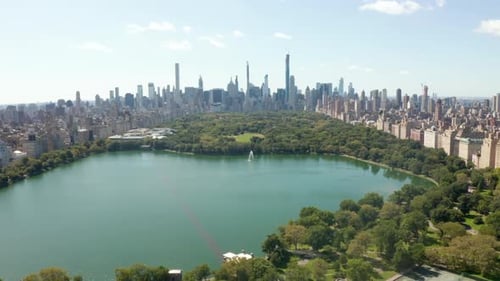 Beautiful Central Park View with Lake and Manhattan Skyline in Background at Sunny Summer