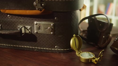 Vintage Suitcase with Brass Compass and Old Cameras