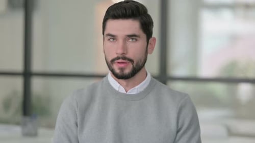 Young Adult Man Looking Seriously at the Camera