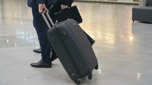 Businessmen Walking Across Terminal