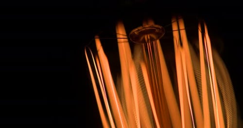 Light Bulb Filaments Glow in Abstract Close Up