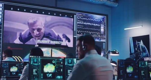 People Work in Futuristic Control Room