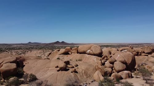 Huge round rocks and mountains on the horizon of a desert, Erongo, Namibia