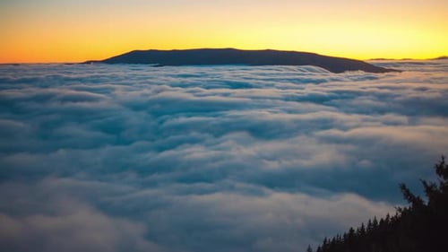 Clouds Blanket a Mountain Range at Sunset