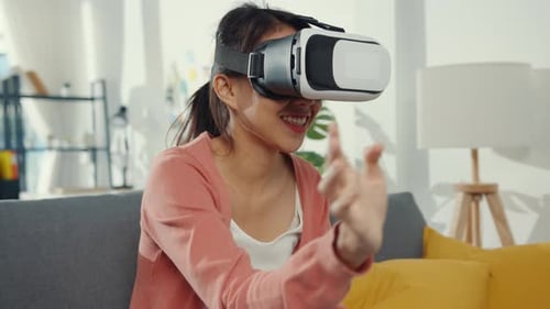 Young Woman Experiencing Virtual Reality Headset at Home