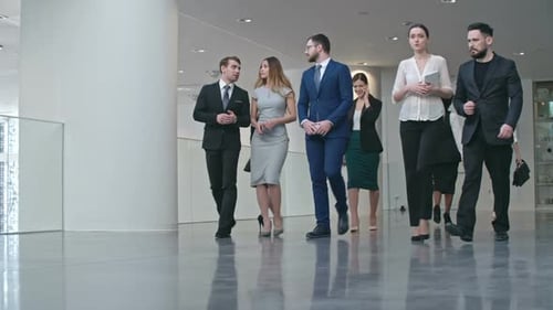 Businesspeople Walking through Hall of Business center