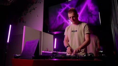 Young Adult DJ Mixing Music at a Club