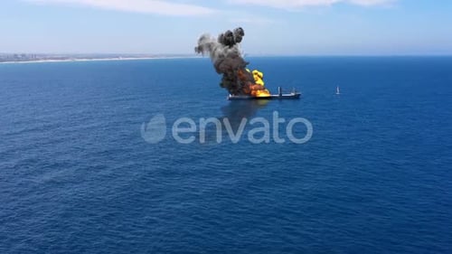 Cargo ship burning on fire with large scale smoke-Aerial