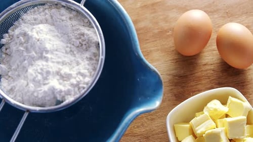 Various ingredients and brown eggs on wooden table 4k