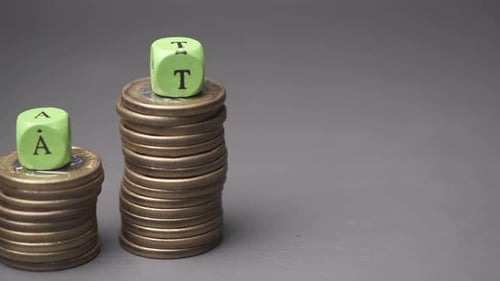 Stacks of Coins Spells Tax Concept
