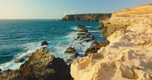 Atlantic Ocean Waves Splash on Volcanic Rocky Caves Limestone Sandstone Formations