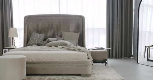 Modern Hotel Bedroom Interior and Bed with Many Pillows