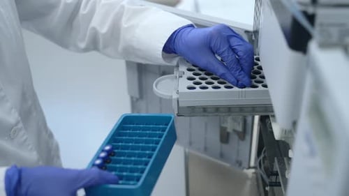 Vials Being Placed in Laboratory Testing Machine
