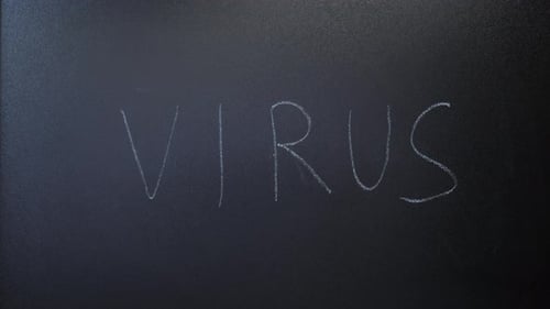 Hand Writes Virus on Chalkboard