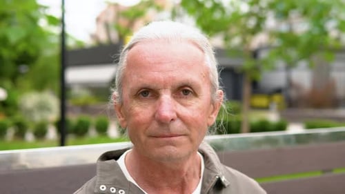 Adult Man Looking into the Camera Outdoors