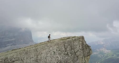 Aerial drone view of a woman hiking in the mountains
