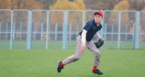Baseball Tournament at School the Boy Pitcher Successfully Catches a Fastball in the Glove and Sends