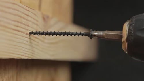 Drill Driving Screw Into Wood Piece Close Up